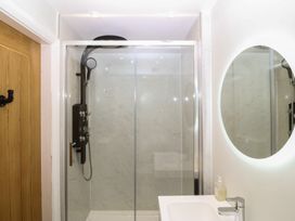 A bathroom with a shower and sink at The Hideaway in Mynytho near Abersoch