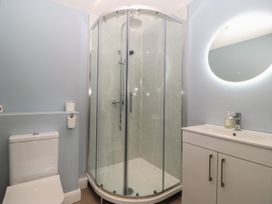 A bathroom with a shower and toilet at The Hideaway in Mynytho near Abersoch