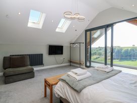 A bedroom with a bed and a TV at The Hideaway in Mynytho near Abersoch