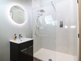 A bathroom with a shower and sink at The Hideaway in Mynytho near Abersoch