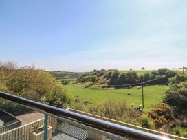 A view of a field with cows and trees at The Hideaway in Mynytho near Abersoch