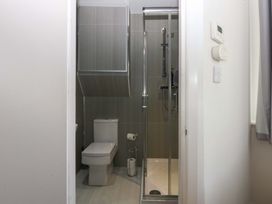 A bathroom with a shower and toilet at Queens Park in Llandudno