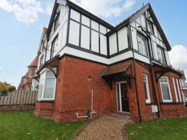 A house with a garden and pathway at Queens Park Llandudno
