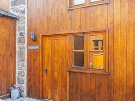 An exterior view of The Hay Store with a wooden door and window in Corwen