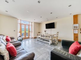 A living room with seating and dining table at Hay Store in Corwen