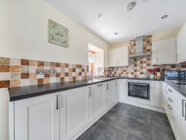 A kitchen with cabinets and an oven at Hay Store in Corwen