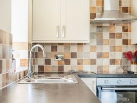 A kitchen with a sink and cooking range at Hay Store in Corwen
