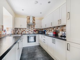 A kitchen with cabinets and appliances at Hay Store in Corwen