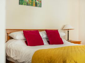 A bedroom with a bed and lamp at Hay Store in Corwen