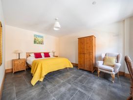A bedroom with a bed and wardrobe at Hay Store in Corwen