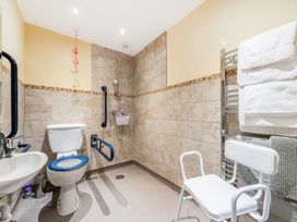 A bathroom with a toilet and sink at Hay Store in Corwen