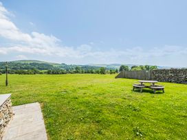 A field with a picnic table and a lamp post at Hay Store in Corwen