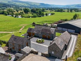 An aerial view of buildings and landscape at The Barn in Corwen
