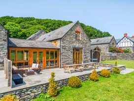 An outdoor space with a house and patio furniture at The Barn in Corwen
