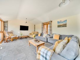 A living room with a sofa and coffee table at The Barn in Corwen