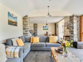 A living room with a sofa and coffee table at The Barn in Corwen