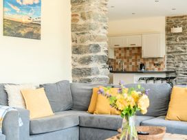 A living room with a sofa and coffee table at The Barn in Corwen