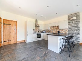 A kitchen with countertops and appliances at The Barn in Corwen