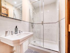 A bathroom with a sink and shower at The Barn in Corwen
