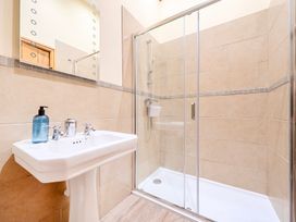 A bathroom with a sink and shower at The Barn in Corwen