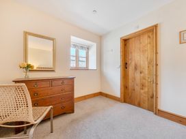 A bedroom with a mirror and a dresser at The Barn in Corwen