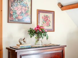 A table with flowers and books at The Barn in Corwen