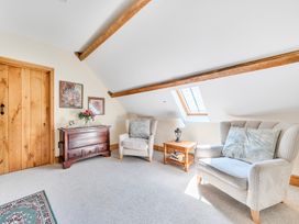 A sitting room with two armchairs and a coffee table at The Barn in Corwen