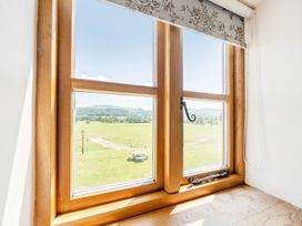 A window with a view of a field and a table at The Barn in Corwen