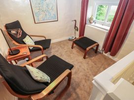A snug with armchairs and footstools at The LA'AL Cragg in Kirkby Stephen