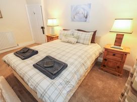 A bedroom with a bed and bedside table at The LA'AL Cragg in Kirkby Stephen