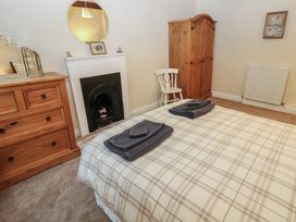 A bedroom with a bed and dresser at The LA'AL Cragg in Kirkby Stephen