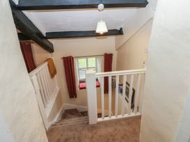 A staircase with a handrail and a window at The LA'AL Cragg in Kirkby Stephen