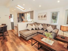 A living room with a sofa and coffee table at Willows Lodge, White Cross Bay, near Windermere