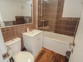 A bathroom with a sink, bath tub and shower at Willows Lodge White Cross Bay near Windermere