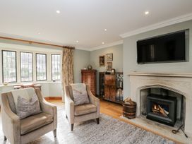 A living room with two chairs and a fireplace at The Old Hall in Tetbury