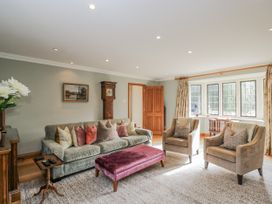 A living room with a sofa and armchairs at The Old Hall in Tetbury