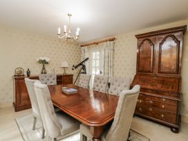 A dining room with a table and chairs at The Old Hall in Tetbury