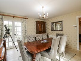 A dining room with a table and chairs at The Old Hall in Tetbury