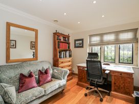 An office with a desk and bookshelf at The Old Hall in Tetbury