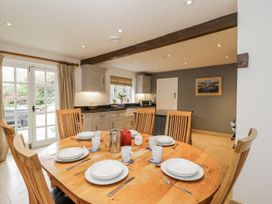 A kitchen with a wooden table and chairs at The Old Hall in Tetbury