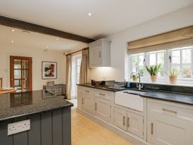 A kitchen with a sink and cooking surface at The Old Hall in Tetbury