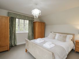 A bedroom with a bed and wardrobes at The Old Hall in Tetbury