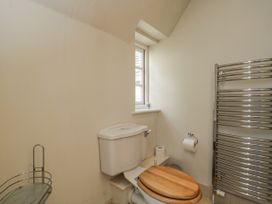 A bathroom with a toilet and window at The Old Hall in Tetbury