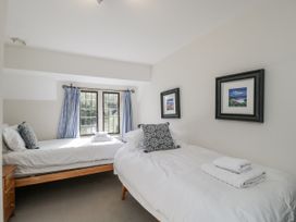 A bedroom with two beds and a window at The Old Hall in Tetbury