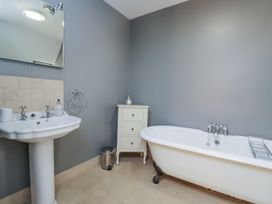 A bathroom with a bathtub and sink at The Old Hall in Tetbury