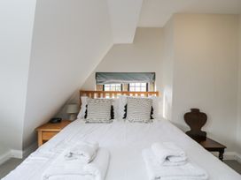 A bedroom with a bed and towels at The Old Hall in Tetbury
