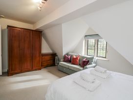 A bedroom with a bed and wardrobe at The Old Hall in Tetbury
