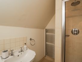A bathroom with a tub and shower at The Old Hall in Tetbury