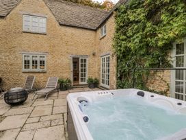 An outdoor area with a hot tub and seating at The Old Hall in Tetbury