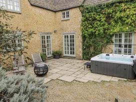 An outdoor area with a hot tub and seating at The Old Hall in Tetbury